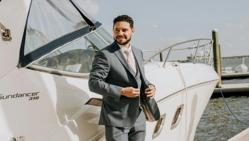 Man in a suit by a boat