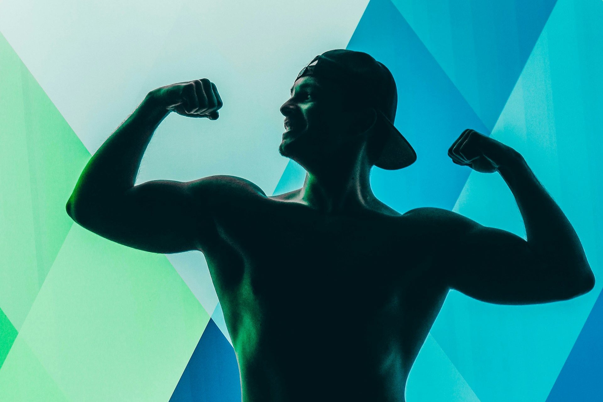 Muscular guy in hat silhouette bright colors in background